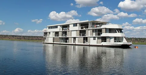 The Zambezi Queen, a sleek 14-room river boat, sails along the Chobe River, through one of Africaâs densest concentrations of wildlife. (Colleen Clark)