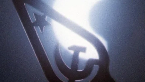 A solar eclipse seen in behind a hammer and sickle placed on the top of a flagstaff in Kiev, Ukraine. (Associated Press)