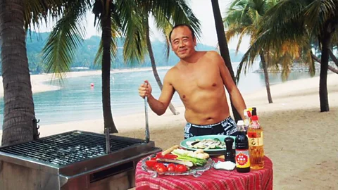 Chef Ken Hom cooking traditional cuisine on Singapore's Sentosa Beach. (BBC)