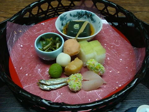 One course of a kaiseki meal, featuring wild vegetable shoots and seafood. (Wendy Yanagihara)