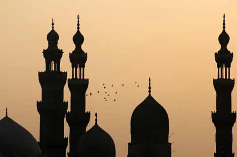 Minarets in Cairoâs Islamic quarter are silhouetted against the evening sky. (Patrick Syder/LPI)