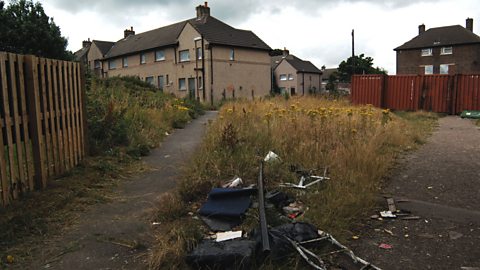 Estate of boarded up homes and dumped rubbish