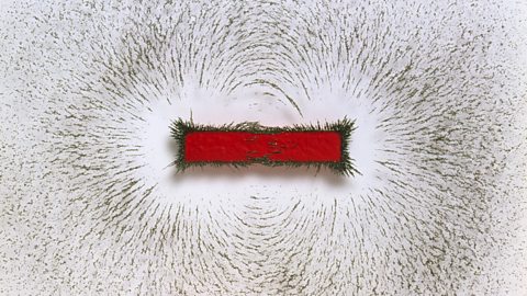 The magnetic field created by this bar magnet is shown using iron filings