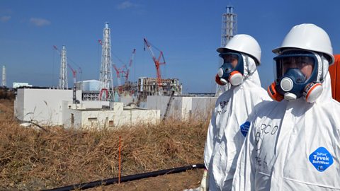 Scientists wearing safety clothing near the Fukishima nuclear plant