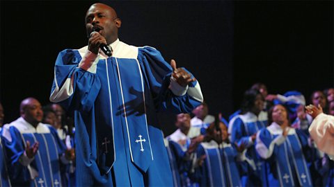 A Gospel choir sings on stage