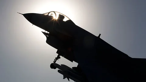 Replica of a Chinese-made fighter jet silhouetted against the sun in Beijing. (AP Photo)