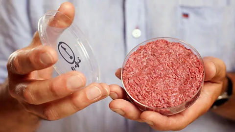 Professor Mark Post with the world’s first lab-grown beef burger, made from around 20,000 strands of protein cultured from cattle stem cells. It cost £250,000 to make. (Reuters)