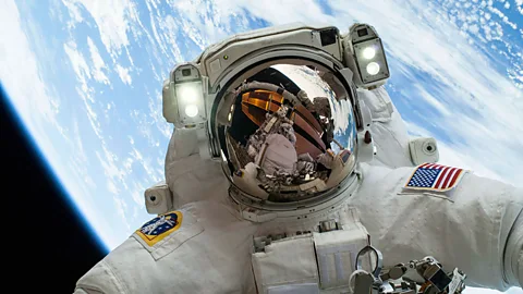 Astronaut Mike Hopkins is pictured while carrying out the second of his two spacewalks – with photographer and fellow astronaut Rick Mastracchio seen in his visor. (Nasa/Reuters)