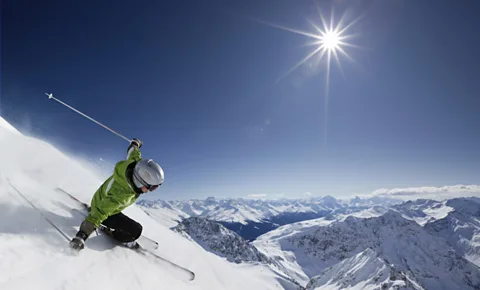 A skier descends from the top of a peak overlooking the Davos valley, Switzerland where the World Economic Forum 2014 is meeting (Thinkstock)