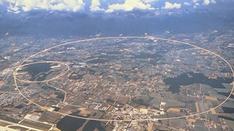 Aerial photograph of CERN in Switzerland. A circle with a diameter of 8.5 km is superimposed to show the location of the Large Hardron Collider