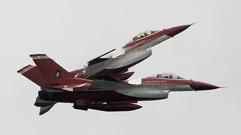 Two F-16s of the Singaporean Air Force display team the Black Knights, captured during a performance at the Singapore Airshow. (AP)