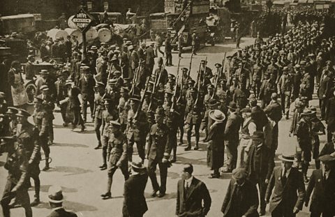 Marching soldiers on parade through a peacetime street