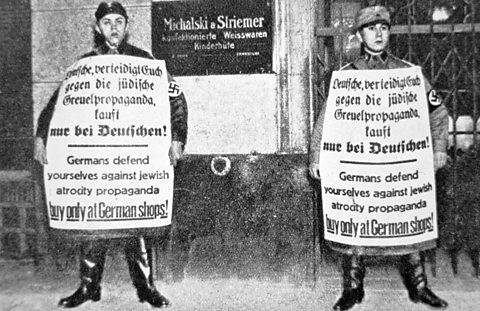 Nazi soldiers outside a Jewish shop during the 1933 April Boycott  