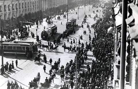 Cavalry police and large crowd of demonstators on a Russian street