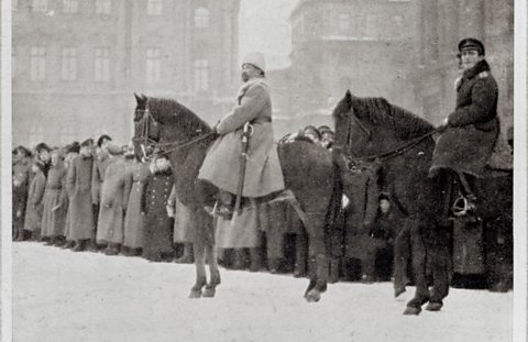 Solider on horseback with fur hat and sabre