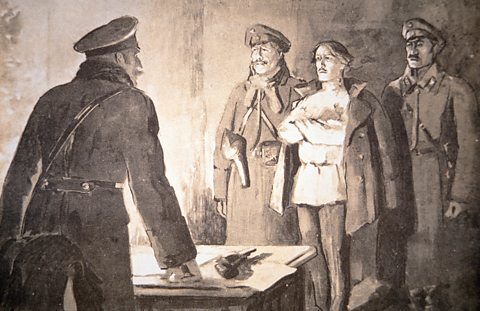 Artist's impression of  man standing with arms folded flanked by two soliders. A Cheka officer, his pistol before him on a desk, asks questions.