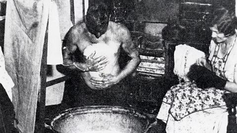 Man washing at a steel bath