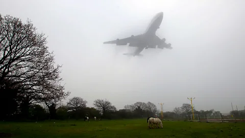 A plane comes in to land at Heathrow Airport, west London, during heavy fog caused by pollution and dust blown up from the Sahara Desert. (PA)