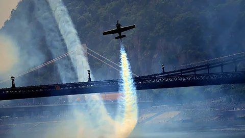 Hungarian pilot Zoltan Veres flies under the oldest Hungarian bridge, the 'Lanchid' (Chain Bridge) with his 'MXS' type plane. (Getty Images)