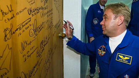 The day of the launch, it’s customary for the crew to sign their name on the door of their bedroom (Nasa/Getty Images)