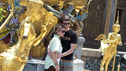 Tourists pose with sculptures at Bangkok's Grand Palace. (Pornchai Kittiwongsakul/AFP/Getty)