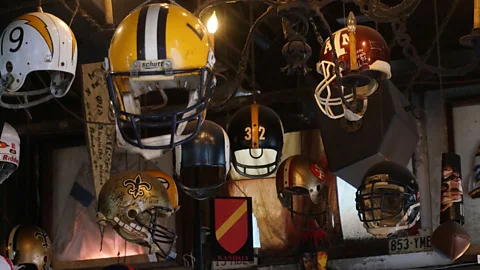 At Jean Lafitte’s Old Absinthe House, vintage football helmets hang from the ceiling and business cards paper the walls. (Brad Cohen)