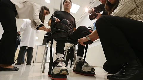 A man paralysed in a construction accident is outfitted with an exoskeleton made by Ekso Bionics (Mario Tama/Getty Images)