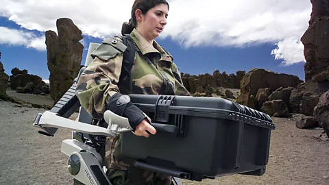 The Hercules robotic exoskeleton helps a female soldier lift a heavy load (SPL).