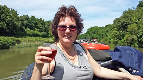 Julie Hando raises a glass on the couple’s narrowboat. (Steven Hando)