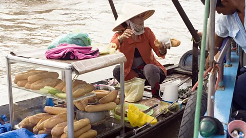 A banh mi vendor on a boat in Vietnam. (Jupiter Images/Getty)