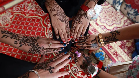 Yemeni girls show their hands decorated with traditional henna designs as they celebrate the end of Ramadan (Getty Images)