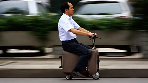 Chinese farmer He Liang spent 10 years turning this suitcase into a motor-driven vehicle travelling at speeds of up to 20km/h (12mph). (Reuters)