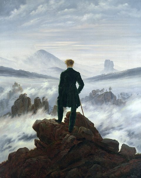 Oil painting of a figure seen from behind looking out over a foggy landscape through which the tops of mountains emerge