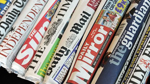 A selection of rolled up national newspapers