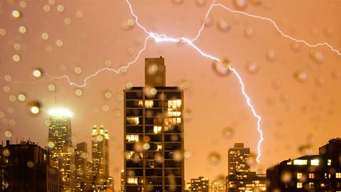 Lightning strike over city skyline at night