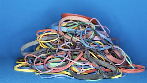 Pile of rubber bands on blue background