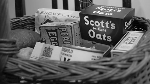 A black and white photo of food rations in a basket