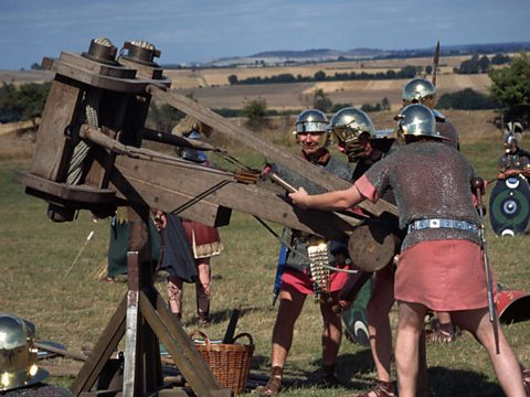 Roman soldiers firing a catapult. 