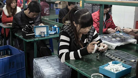 Kate Davies/Unknown Fields Workers in a factory in Shenzhen make MP3 players (Credit: Kate Davies/Unknown Fields)