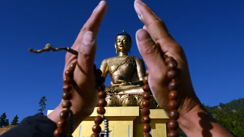 Prakesh Mathema/AFP/Getty A devotee before the Buddha Dordenma statue in Thimphu. (Credit: Prakesh Mathema/AFP/Getty)