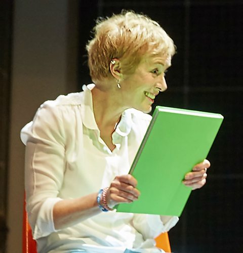 Photo from a stage production of Curious Incident of the Dog in the Night-Time showing Siobhan holding Christopher's note book