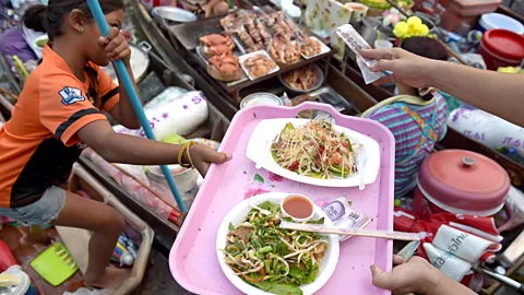 Getty Thai food vendors serve dishes along a canal in Amphawa, west of Bangkok (Credit: Getty)