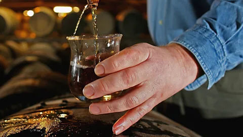 Jeff J Mitchell/Getty Images Taking a whisky sample from a cask at Bruichladdich (Credit: Jeff J Mitchell/Getty Images)