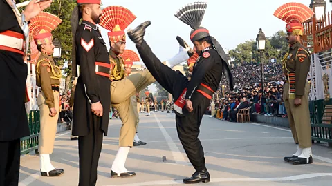 Getty Indian and Pakistani guards face off in a border ceremony (Credit: Getty)