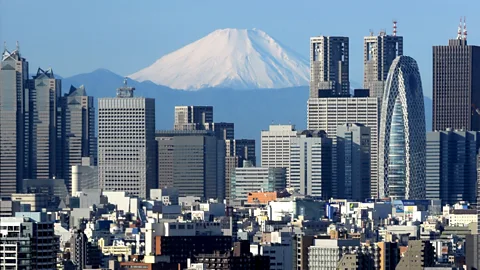 Getty Images Mount Fuji’s symmetric cone serves as a dramatic backdrop to Tokyo (Credit: Getty Images)
