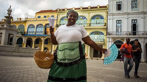 Adalberto Roque/AFP/Getty Images A Cuban peanut seller sings in the street (Credit: Adalberto Roque/AFP/Getty Images)