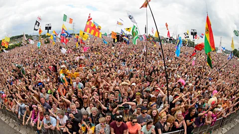 Leon Neal/AFP/Getty Images Would you recognise any of these faces again? Fans enjoy the music at the Glastonbury Festival (Credit: Leon Neal/AFP/Getty Images)