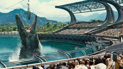 Universal A Mosasaurus chomps down on a shark in Jurassic World (credit: Universal)