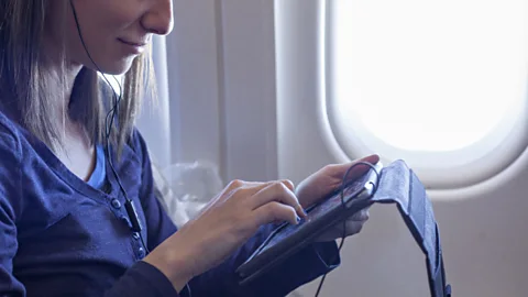 Getty Images Some airlines have already begun replacing seat-based systems with iPads pre-loaded with content (Credit: Getty Images)