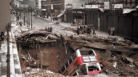 A number 88 bus lies in a crater in Balham High Road